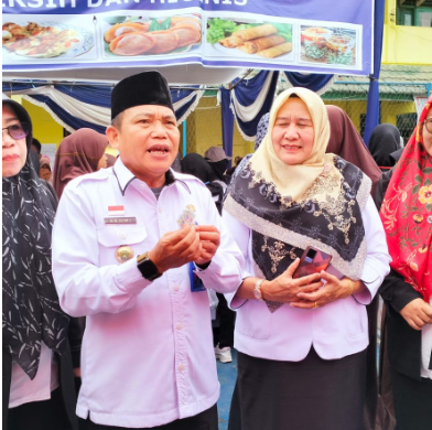Photo 10: School auditorium with students watching a performance on stage, colorful lighting