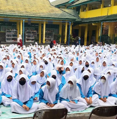Photo 7: Science lab students conducting experiment with test tubes and safety goggles